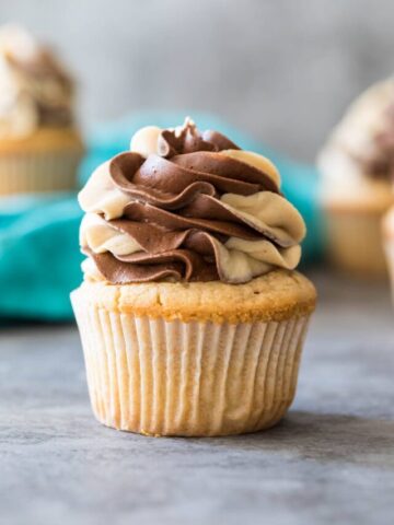 Peanut butter cupcake topped with a swirled chocolate peanut butter frosting.