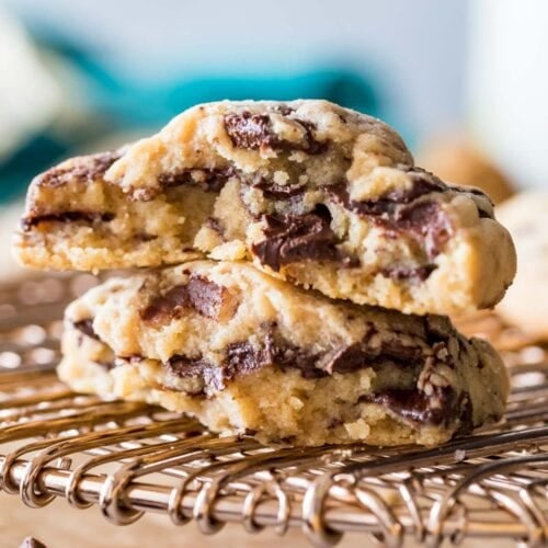 Two halves of a peanut butter chocolate chunk cookie stacked on top of each other.