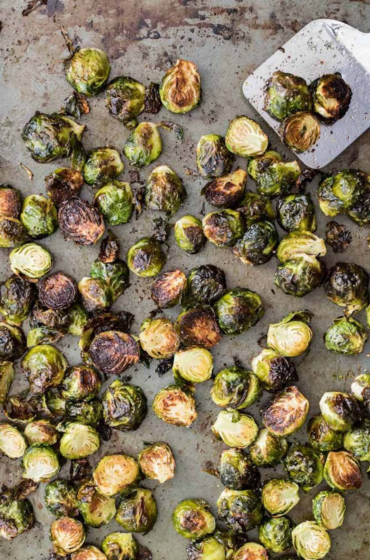 Overhead view of a tray of brussels sprouts after roasting.
