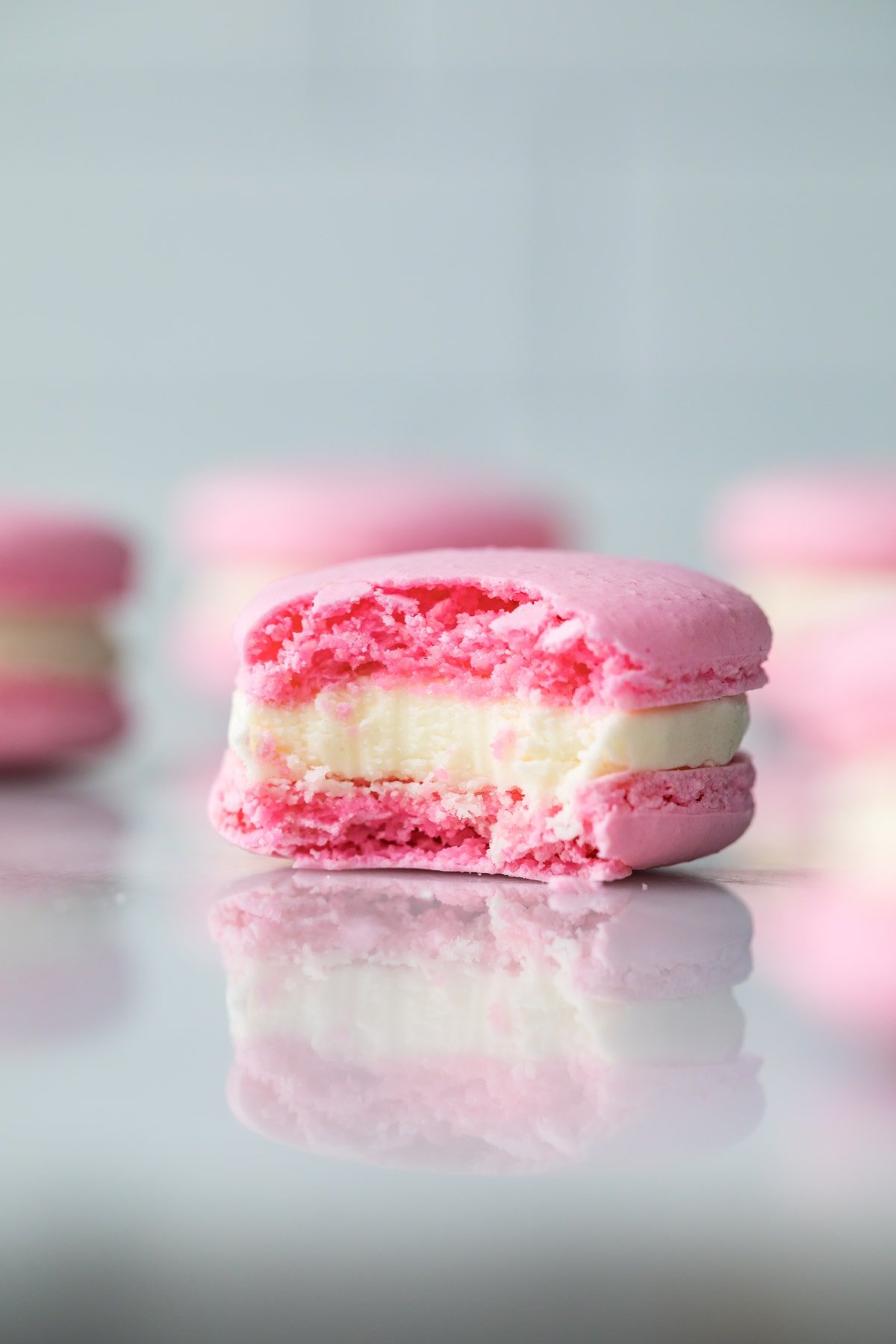 Macaron that has been bitten into, showing full shells and frosting layer