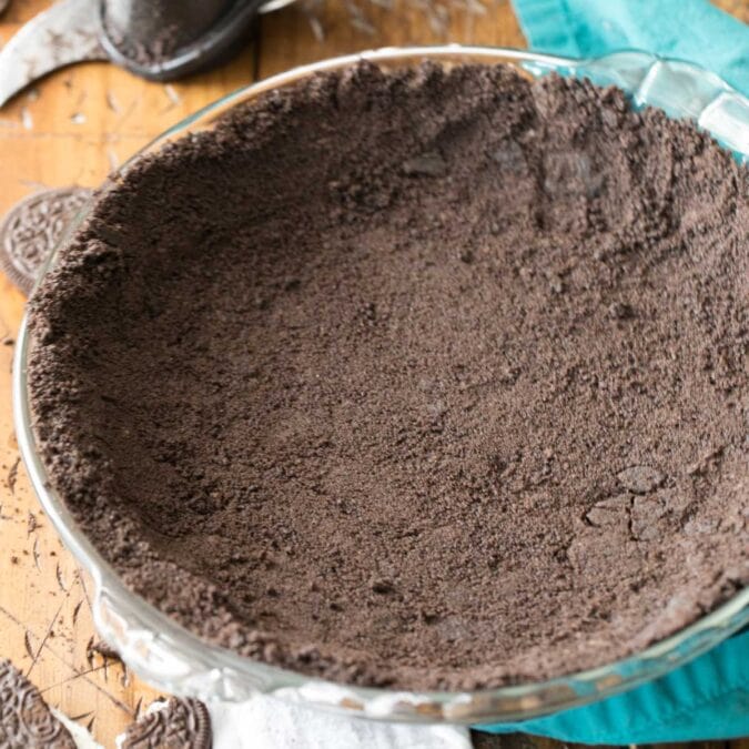 Overhead view of an Oreo crust that's been pressed into a glass pie plate.