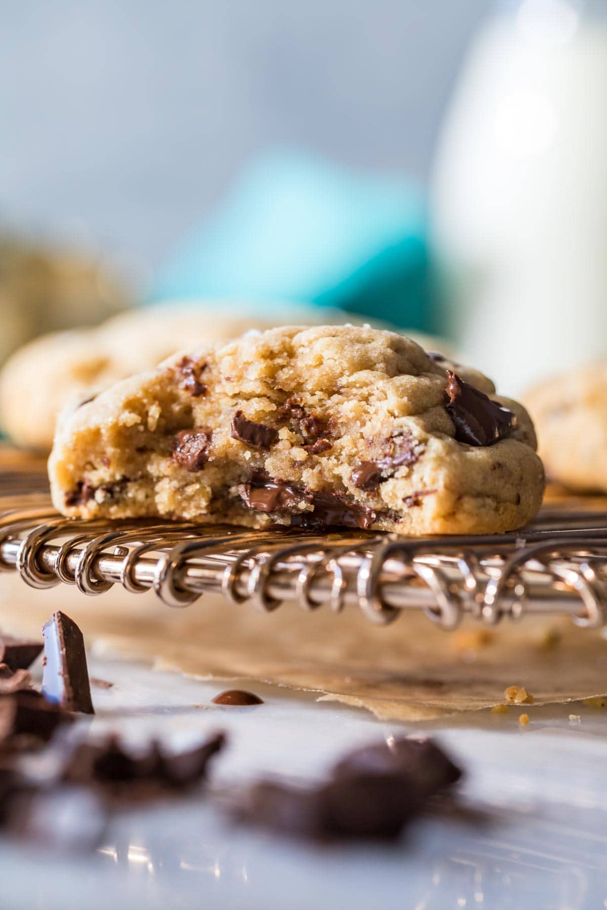 Thick peanut butter cookie bitten in half to show chocolate chunks throughout.