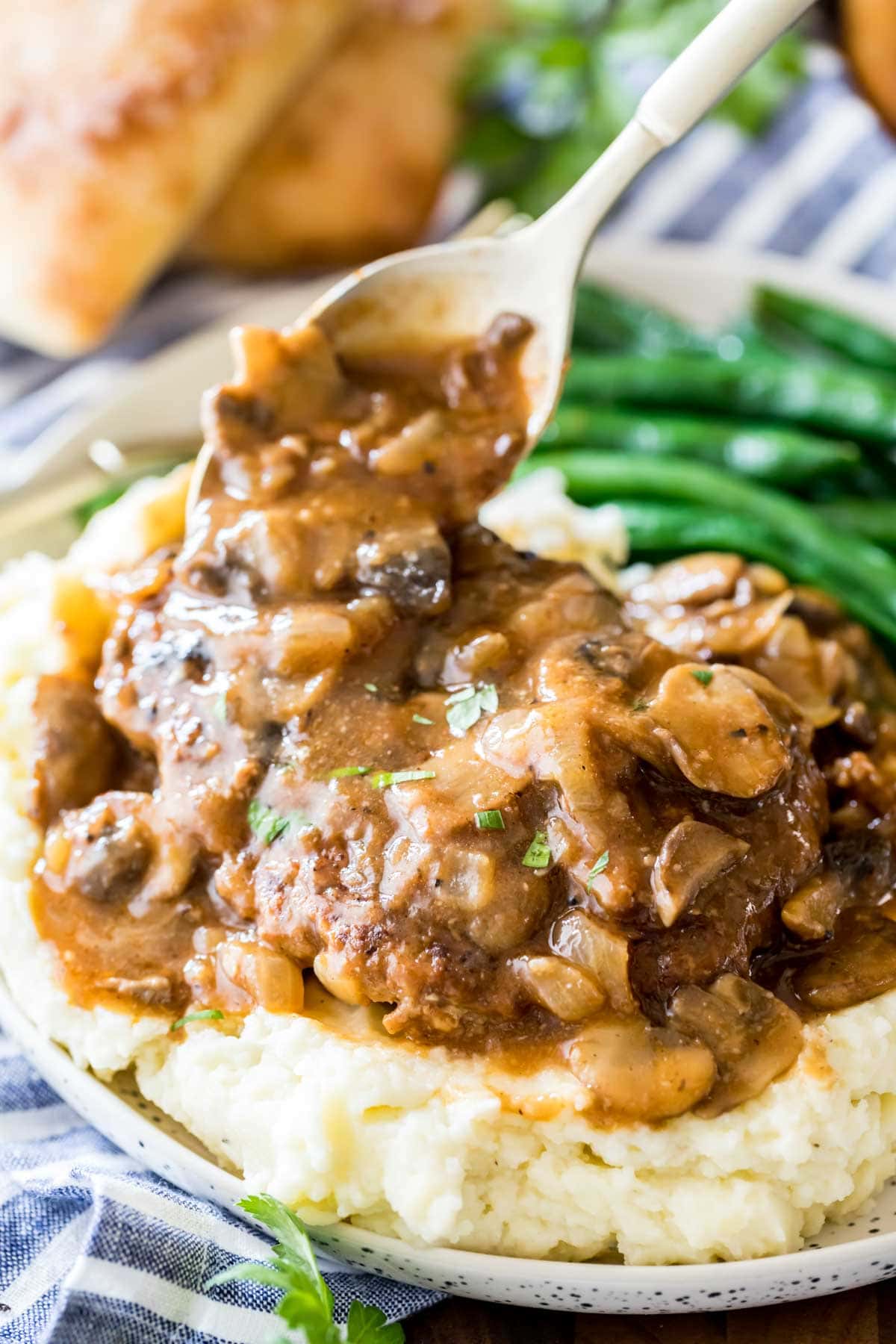 Salisbury steak recipe served over mashed potatoes.