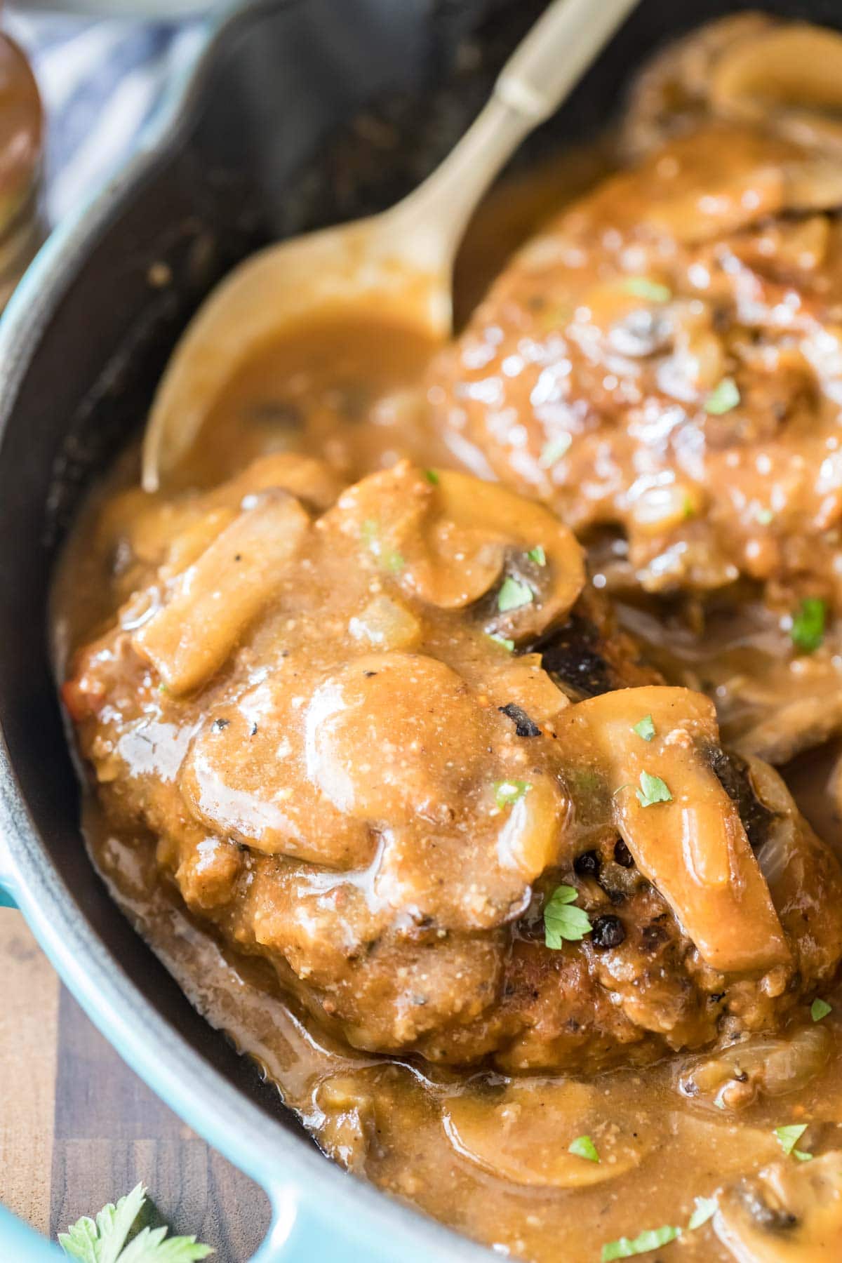 Close-up view of mushroom gravy over ground beef steaks.