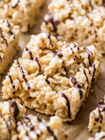 Close-up shot of salted caramel rice krispie treats lightly drizzled with dark chocolate.