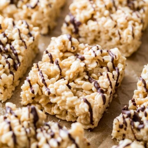 Close-up shot of salted caramel rice krispie treats lightly drizzled with dark chocolate.
