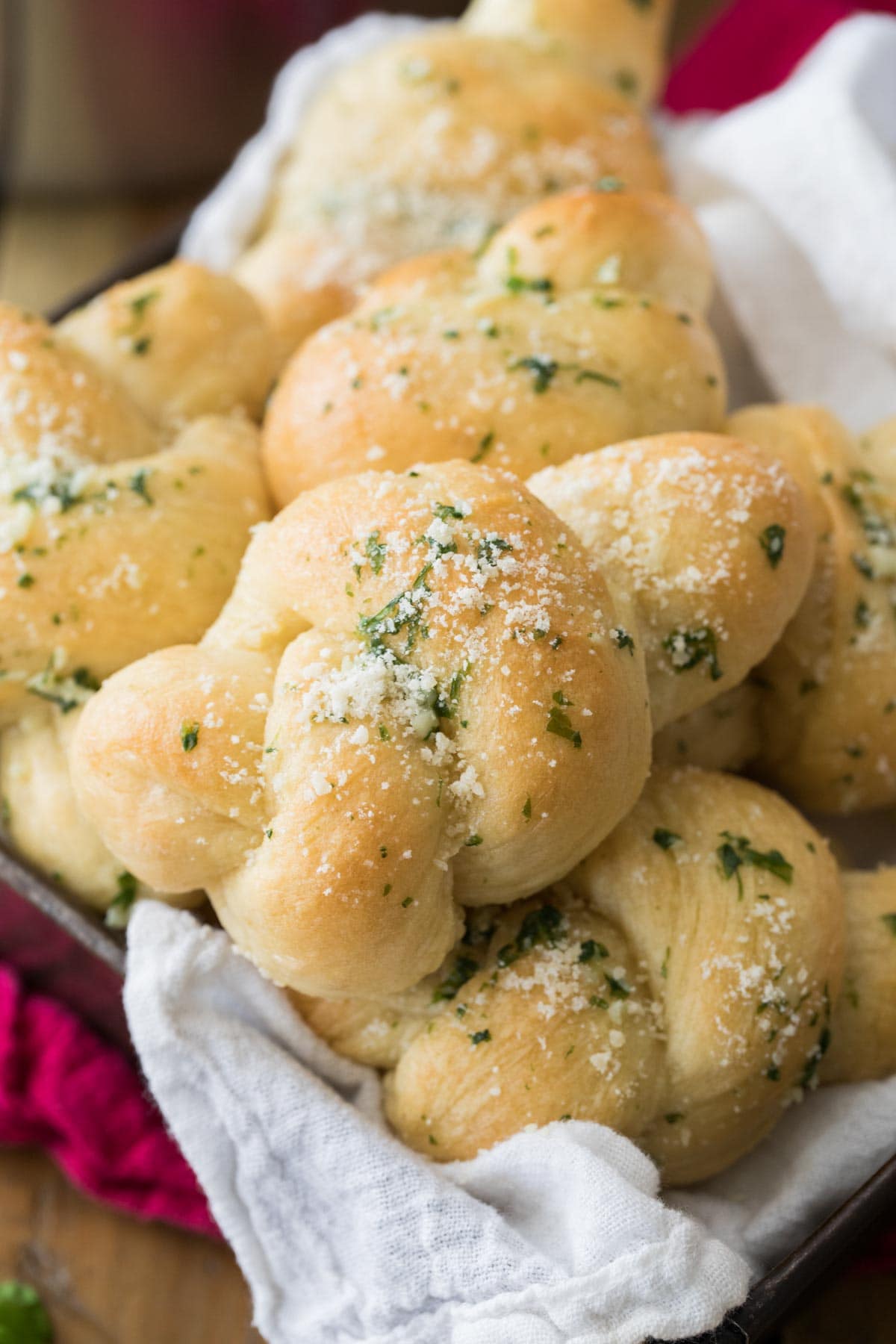 Parmesan and herb coated bread knots in a pile.