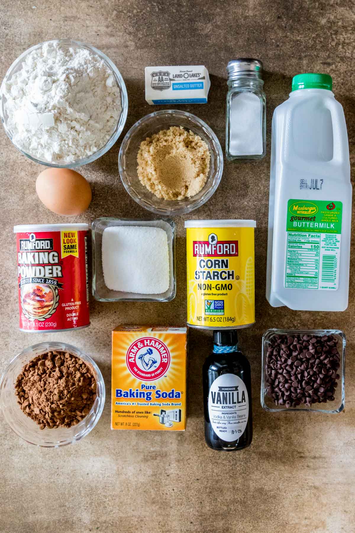Overhead view of ingredients including buttermilk, cocoa powder, chocolate chips, cornstarch, and more.