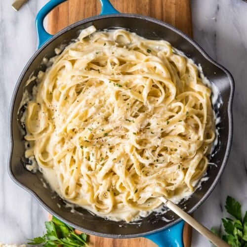 Overhead view of a skillet of fettuccine alfredo.