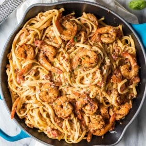 Overhead view of a skillet of cajun shrimp pasta.