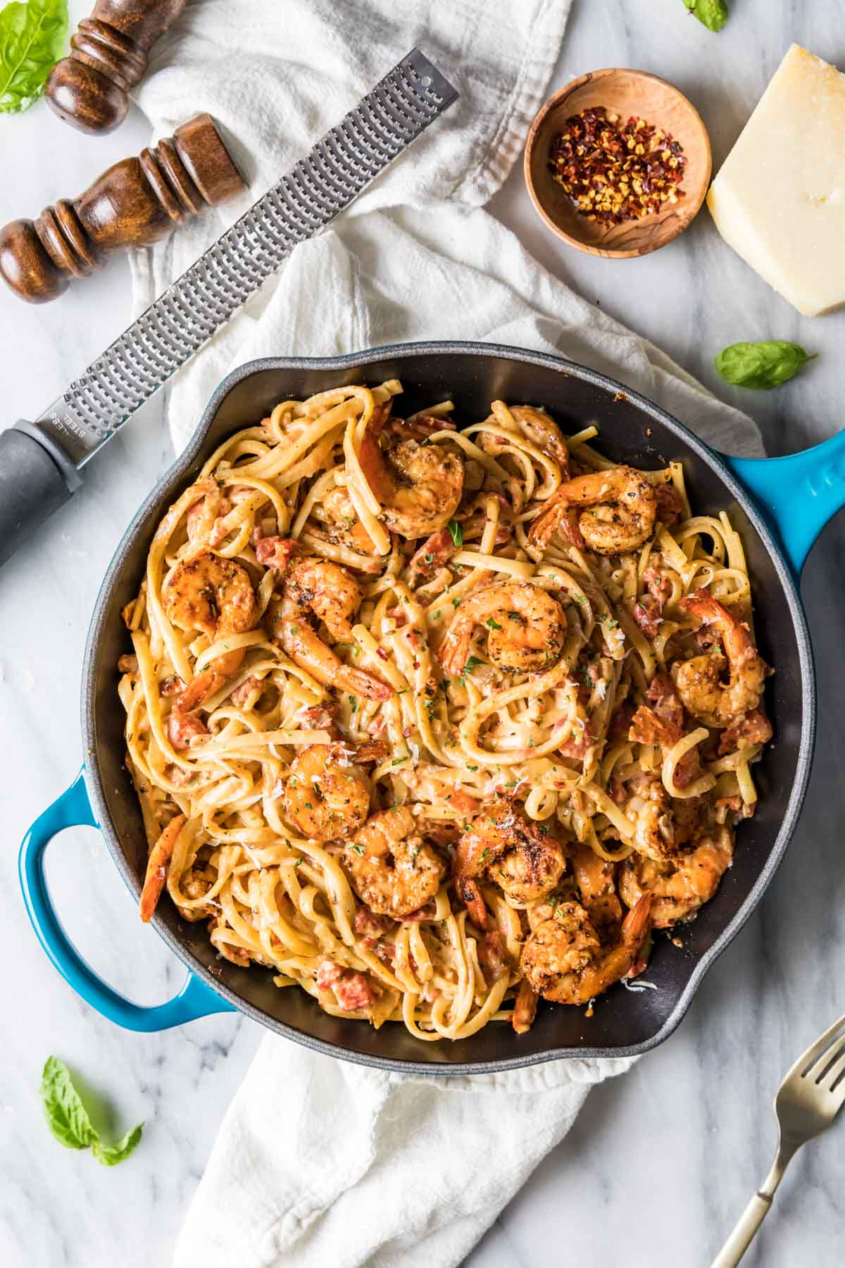 Overhead view of a skillet of cajun shrimp pasta.