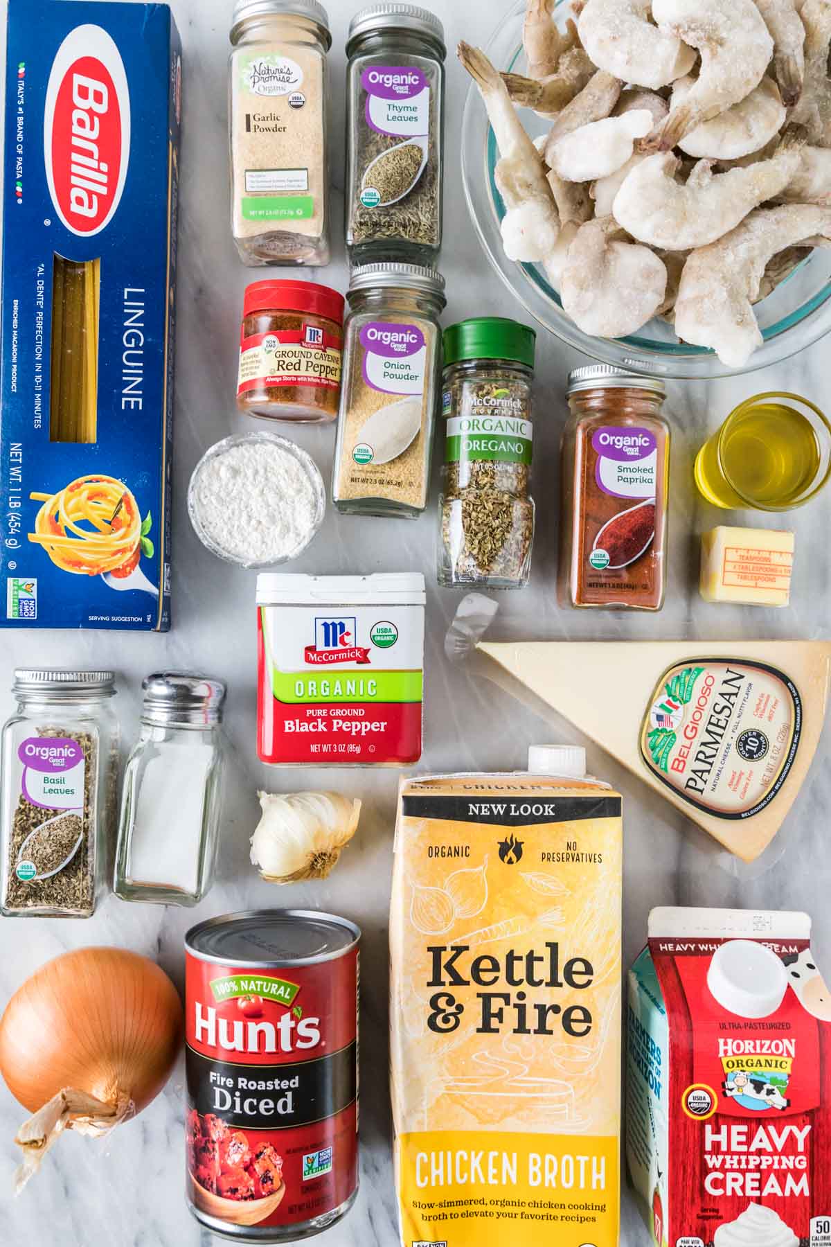 Overhead view of ingredients including spices, pasta, shrimp, and more.