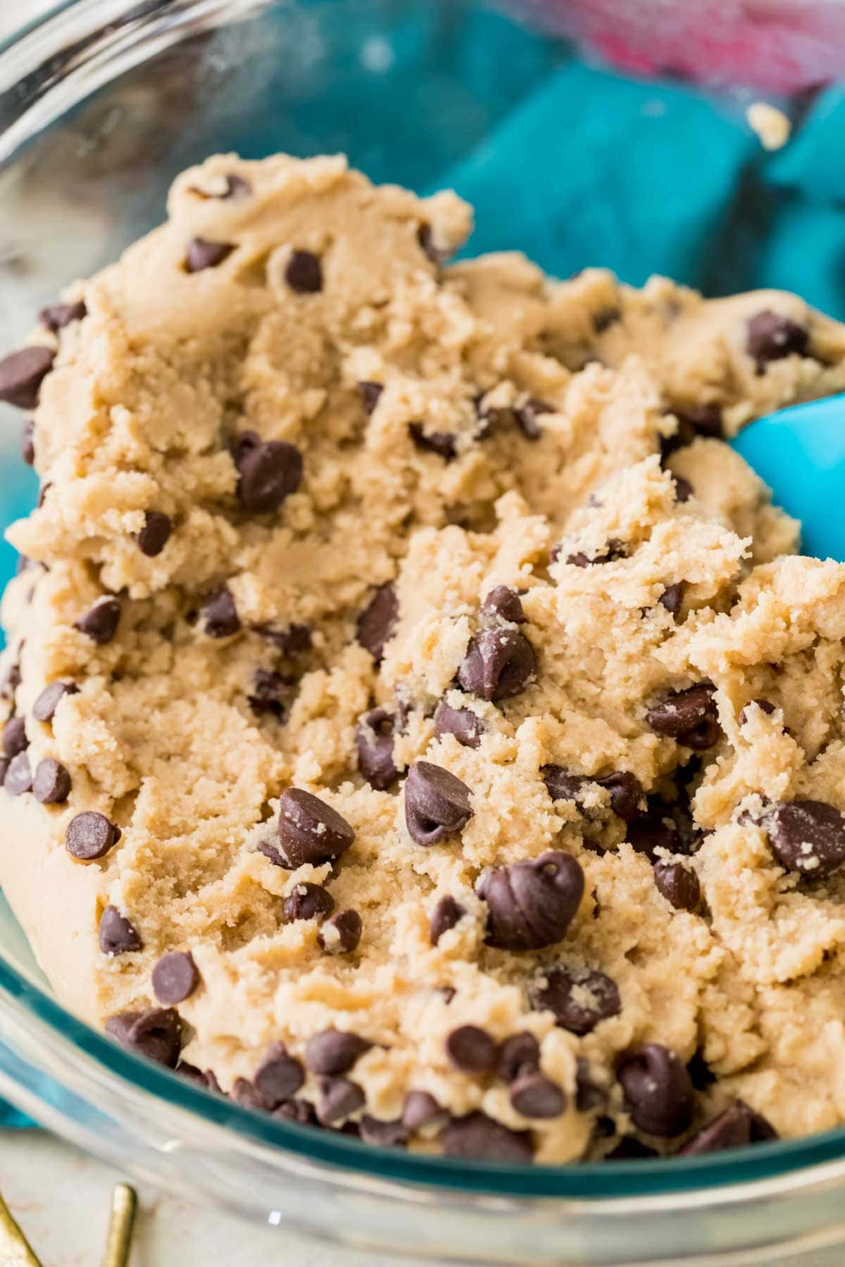 Close-up shot of an edible chocolate chip cookie dough in a bowl.