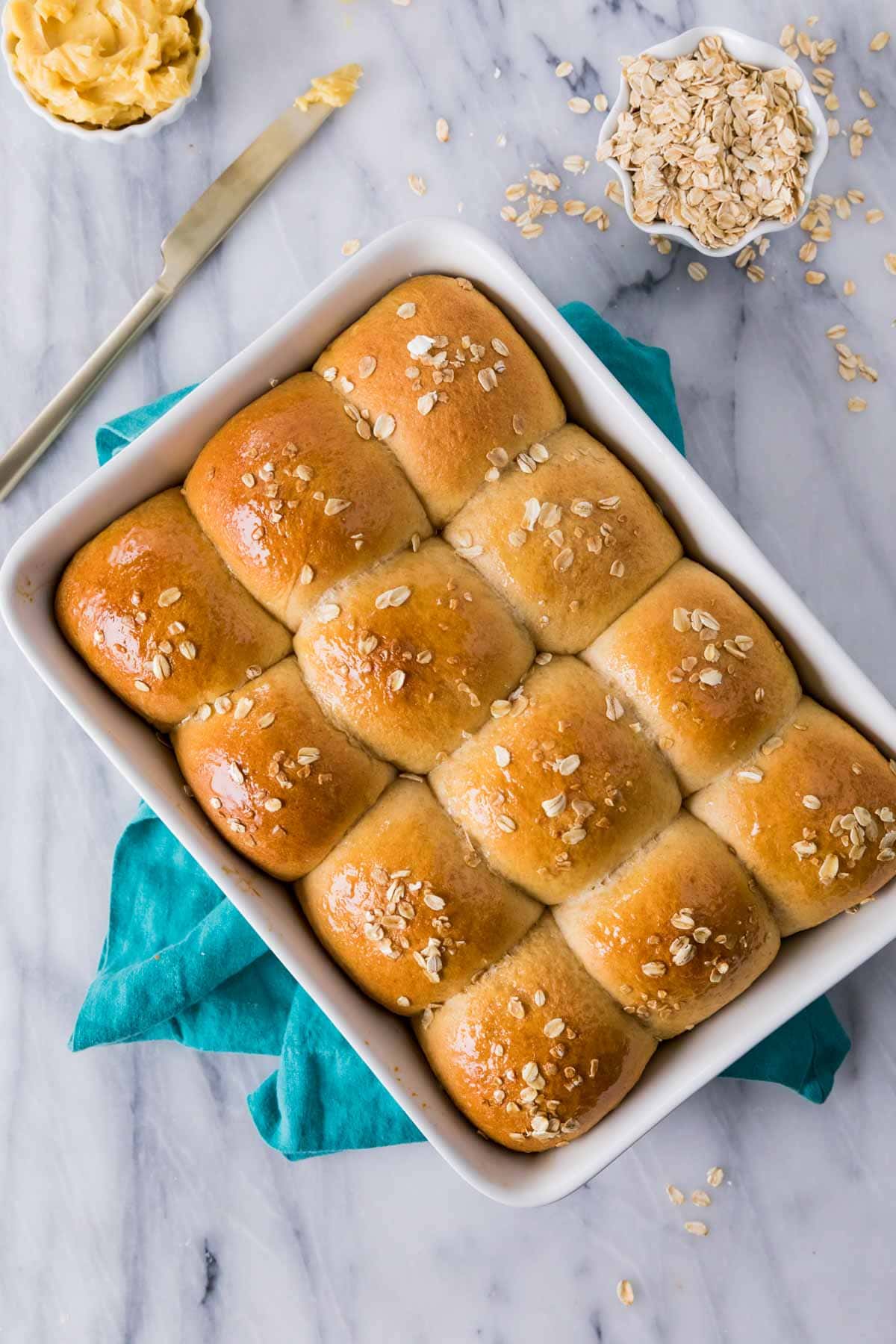 Overhead view of a pan of golden brown honey wheat rolls.