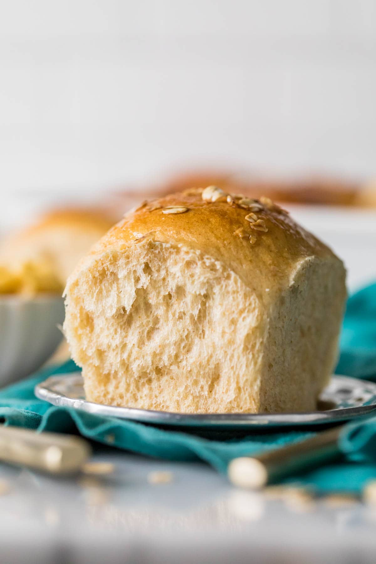 Fluffy honey wheat roll on a plate.