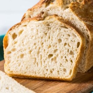 Sourdough bread loaf with a slice resting against it.