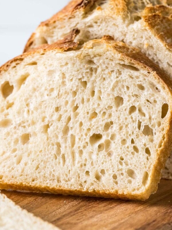 Sourdough bread loaf with a slice resting against it.