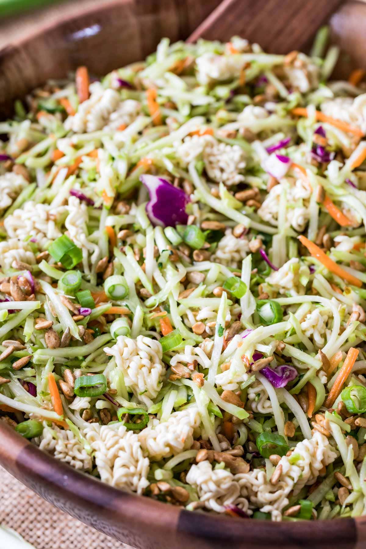 Close-up shot of ramen noodle salad in a wood bowl.