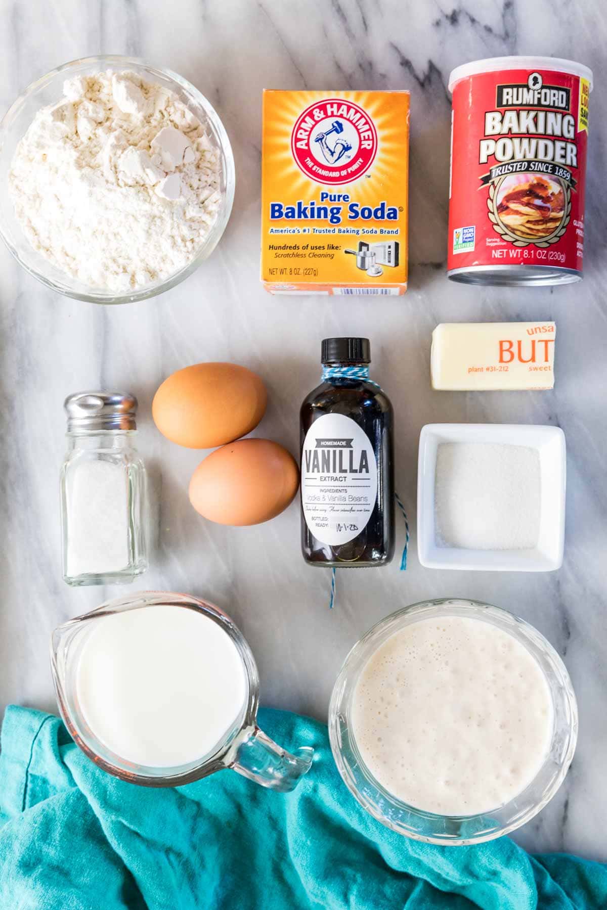 Overhead view of ingredients including flour, sourdough discard, eggs, and more.