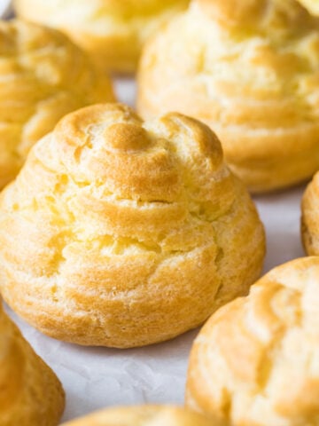 Close-up view of small buns made from choux pastry.