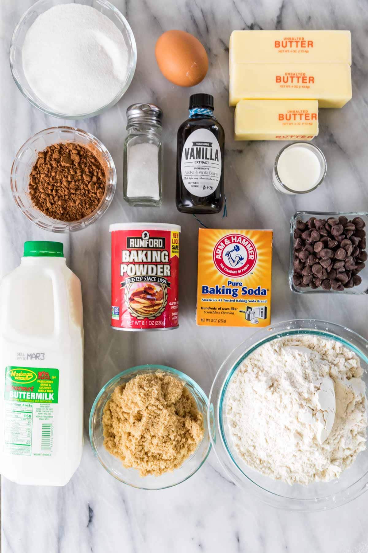 Overhead view of ingredients including buttermilk, cocoa powder, butter, chocolate chips, and more.
