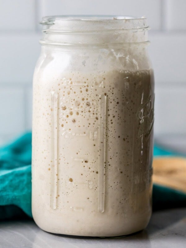 Large glass jar of sourdough starter.