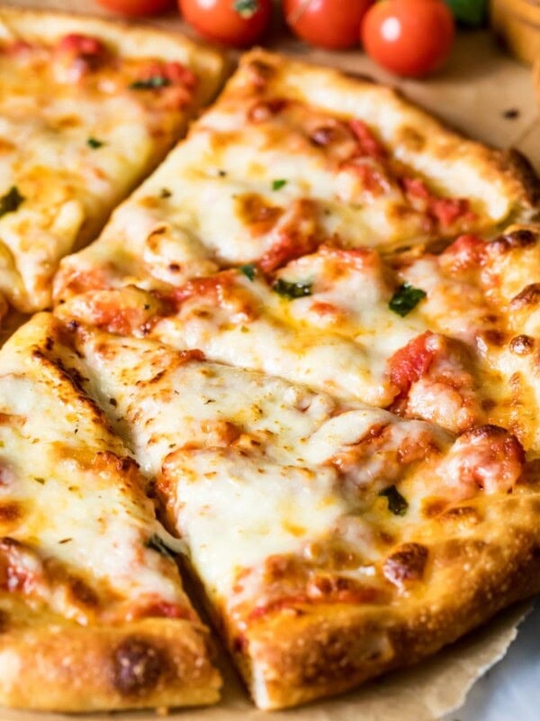 Pizza made from a sourdough pizza crust that has been cut into slices for serving.