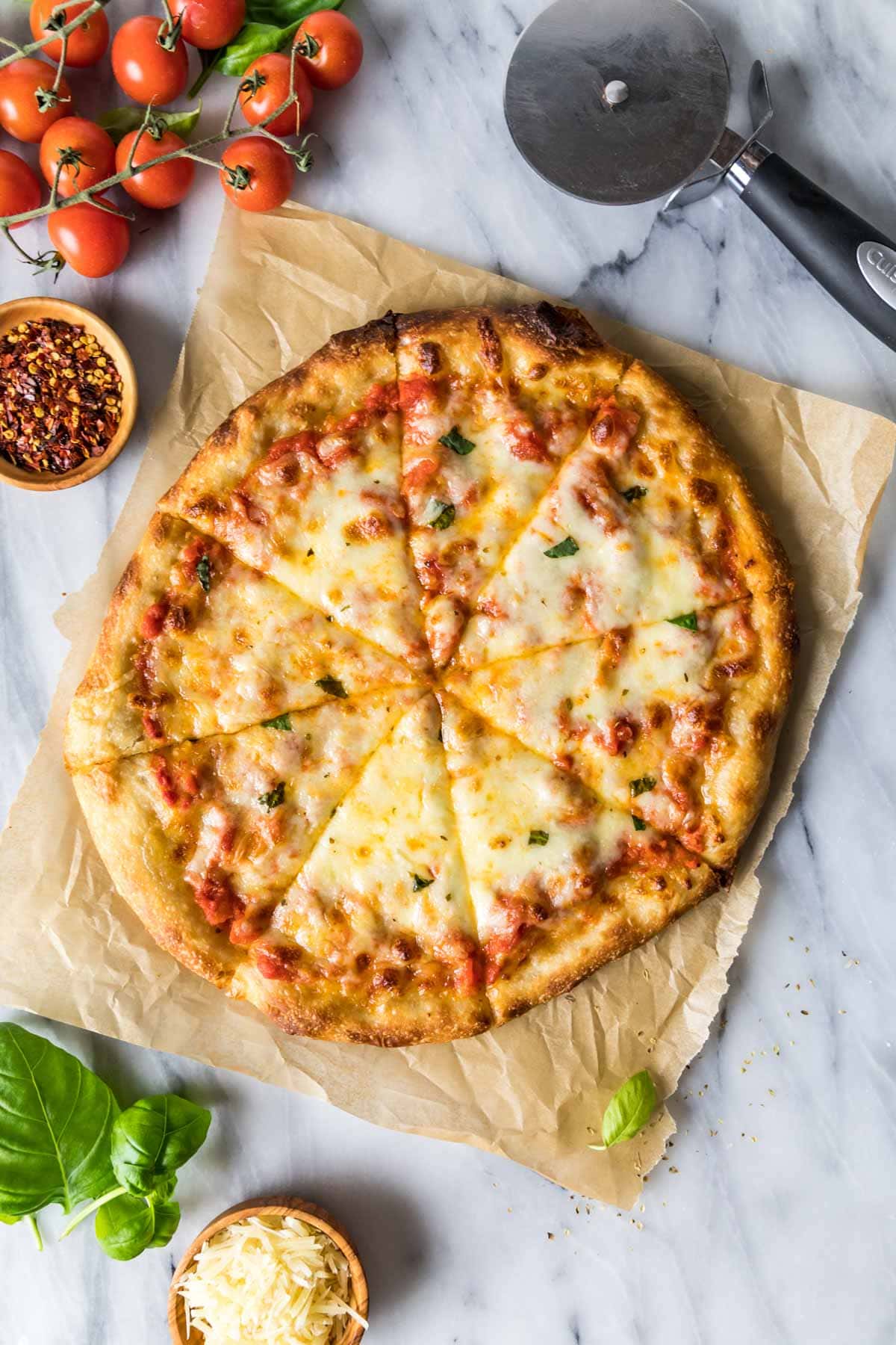 Overhead view of a homemade cheese pizza cut into slices.