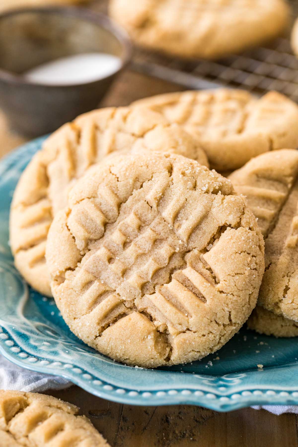Peanut butter cookies with a criss cross fork design  on top.