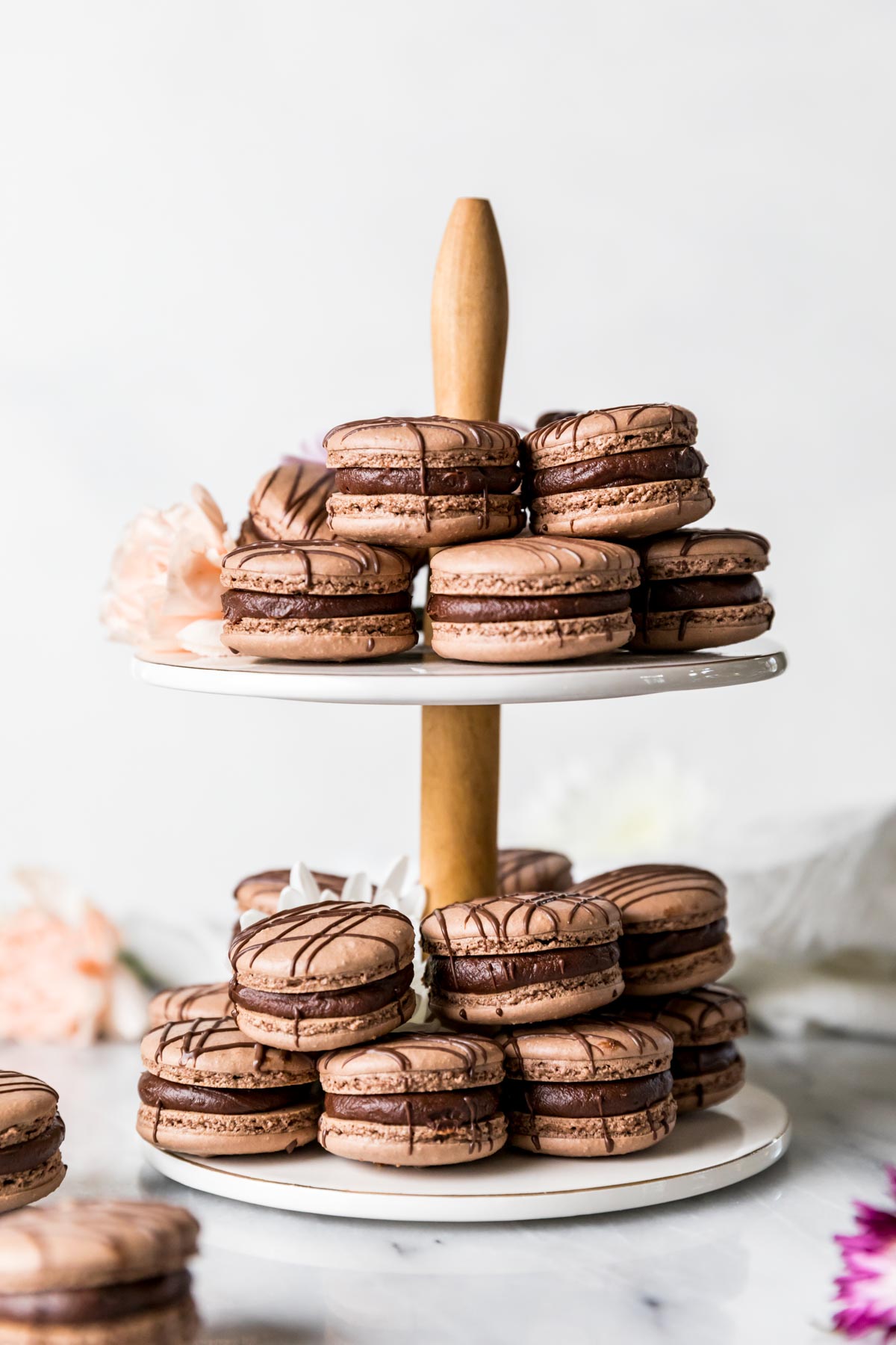 Tiered tray of brown macarons filled with chocolate ganache.