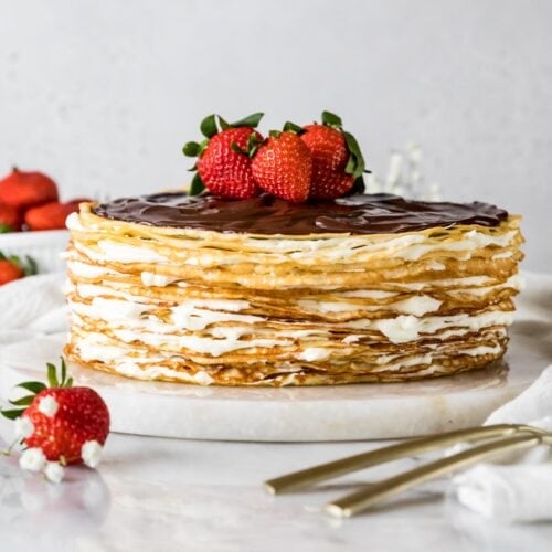 Crepe cake topped with chocolate ganache and fresh strawberries.