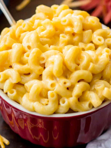 red bowl filled with creamy easy mac and cheese
