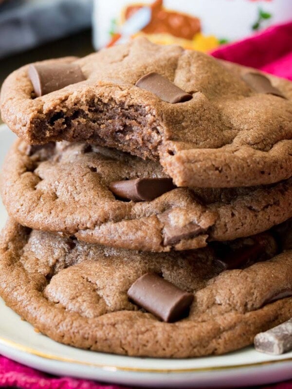 Stack of chocolatey nutella cookies with the top cookie missing one bite.