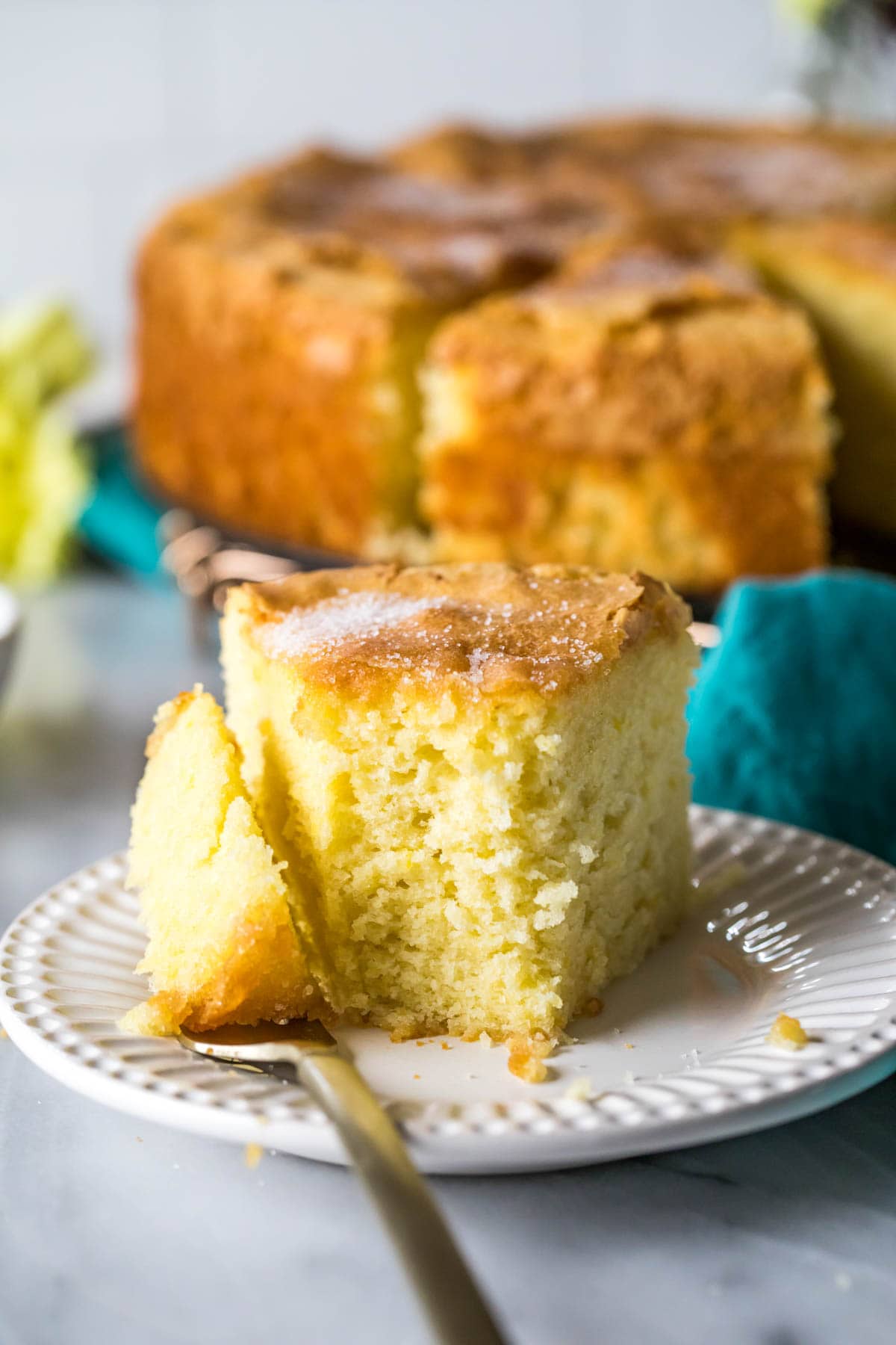 Slice of cake with the first bite on the fork beside it.