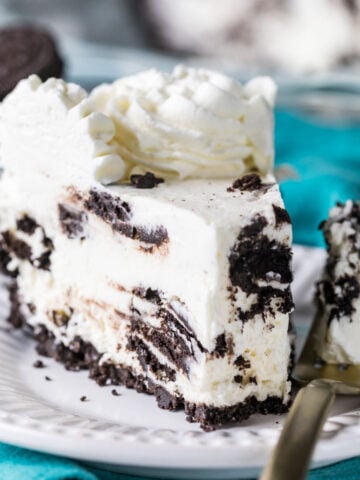 Slice of Oreo pie on a plate with a fork beside it holding the first bite.
