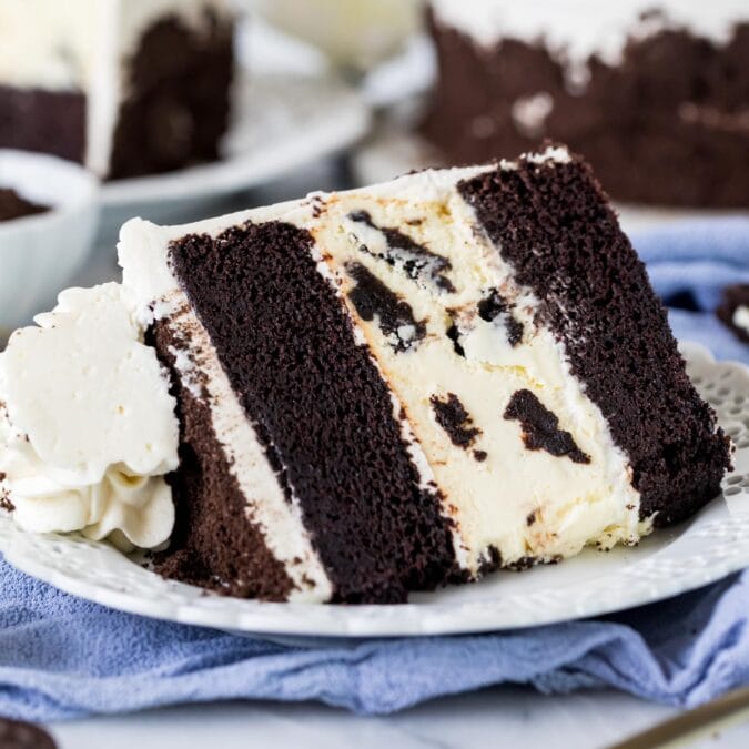 Slice of Oreo cheesecake cake on a plate.