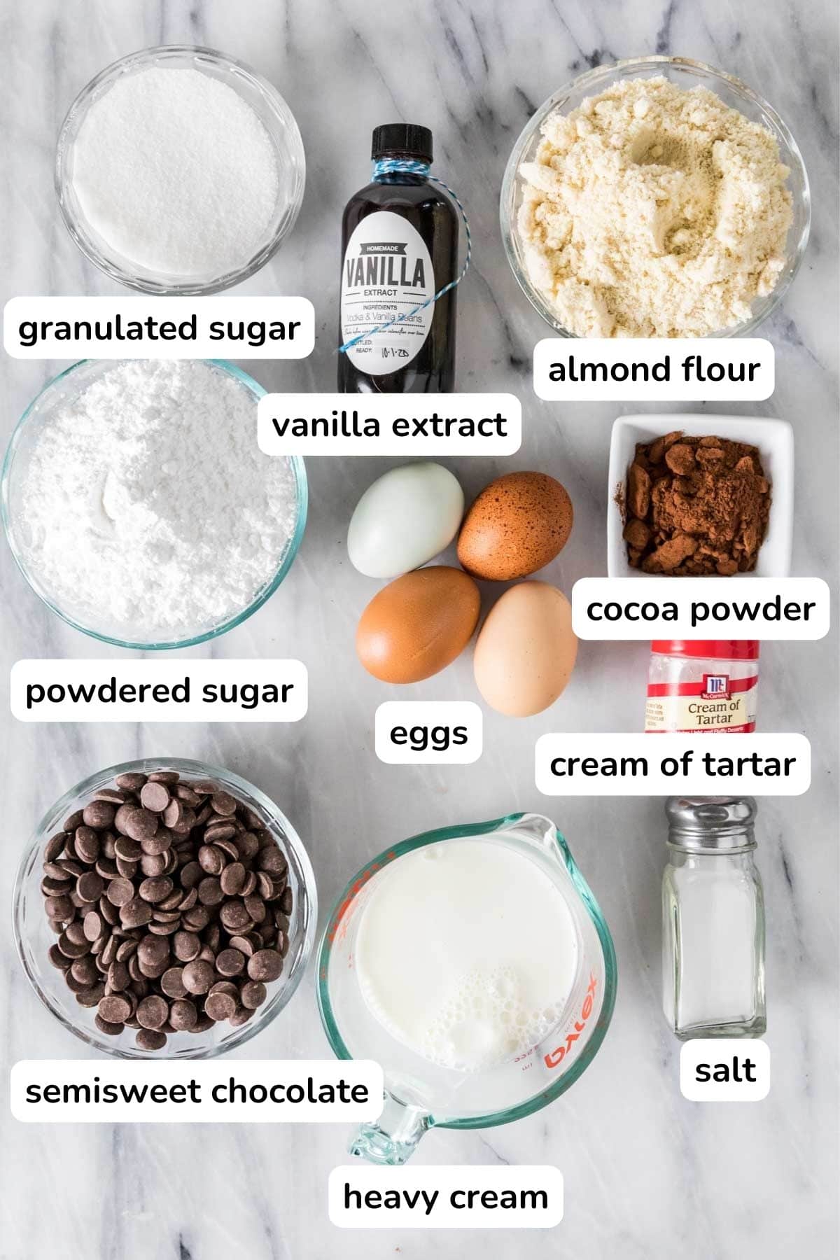 Overhead view of ingredients with labels including cream of tartar, almond flour, egg whites, and more.