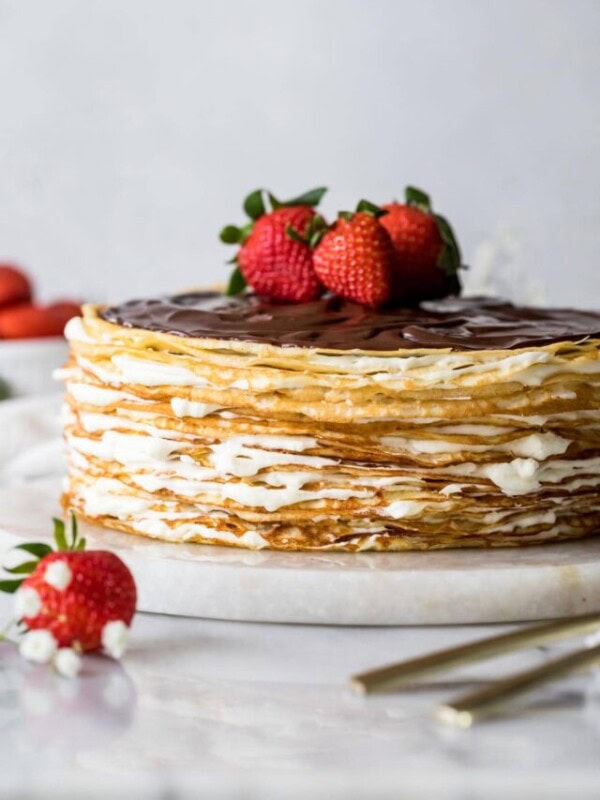Crepe cake topped with chocolate ganache and fresh strawberries.