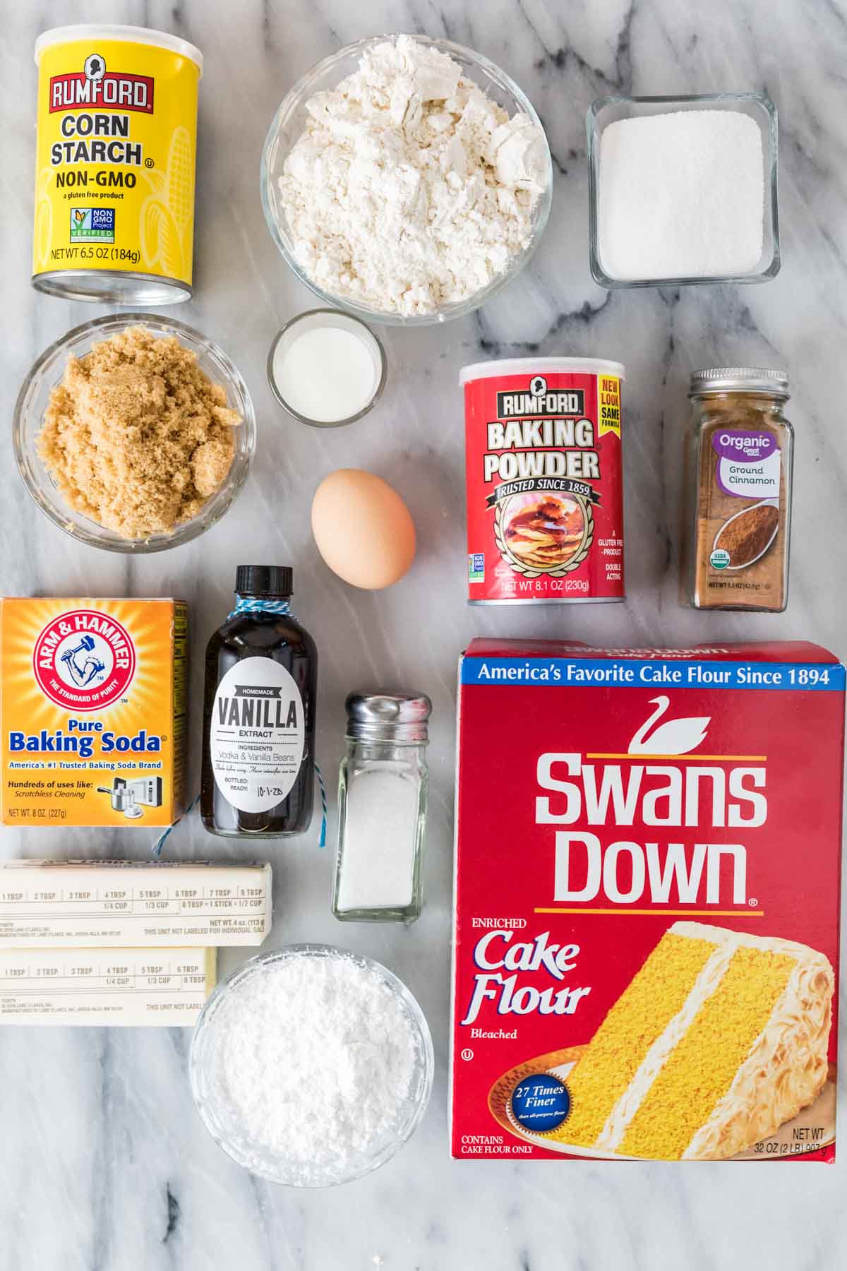 Overhead view of ingredients including cake flour, brown sugar, cinnamon, and more.