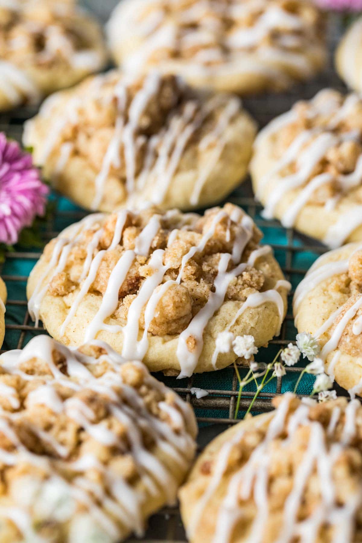 Cookies that have been topped with streusel and a drizzle of glaze to mimic coffee cake.