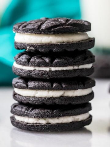 Vertical stack of four cookies made from an oreo cookie recipe.