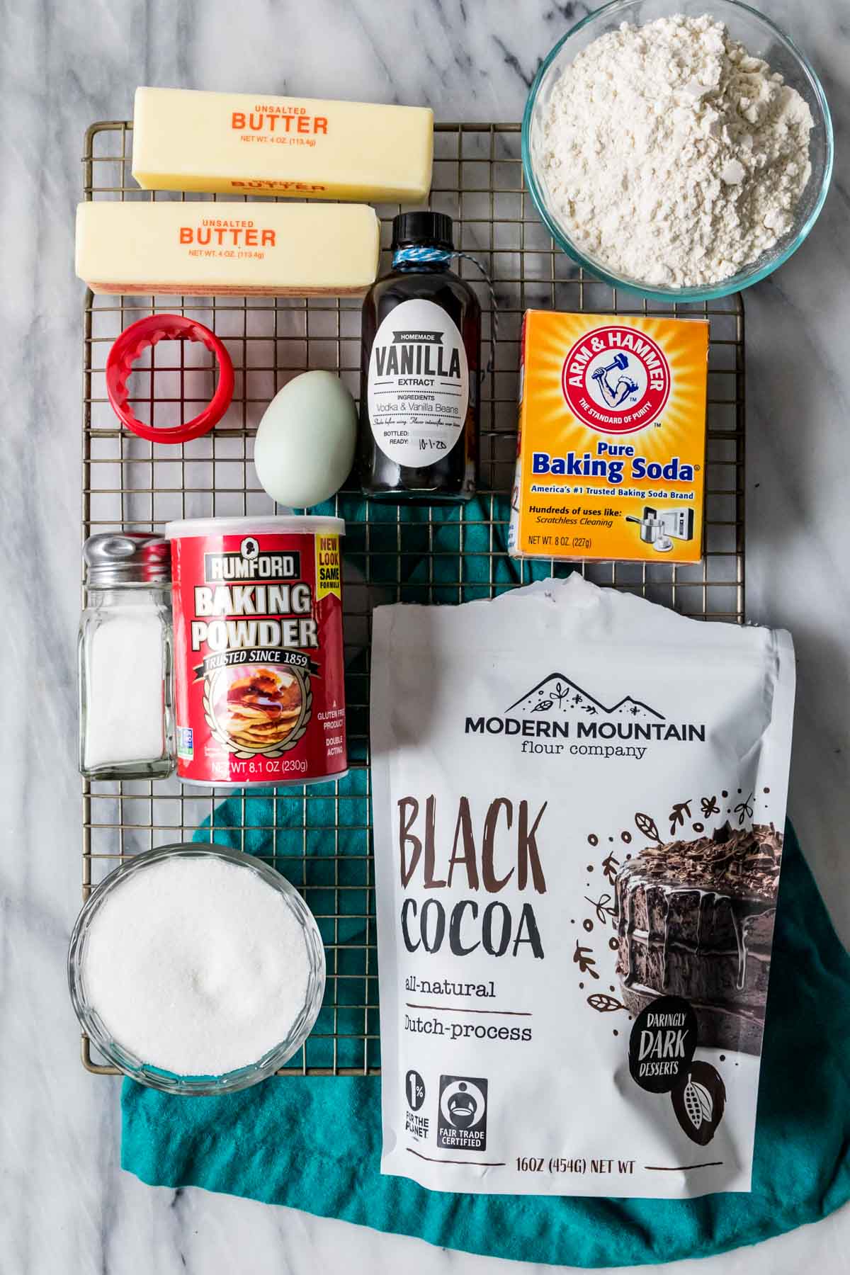 Overhead view of ingredients including black cocoa, butter, flour, and more.