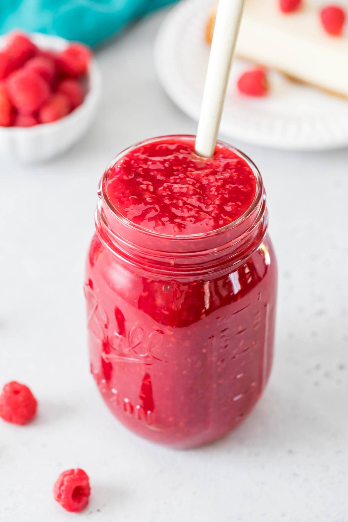 Overhead view of a jar filled with raspberry sauce.