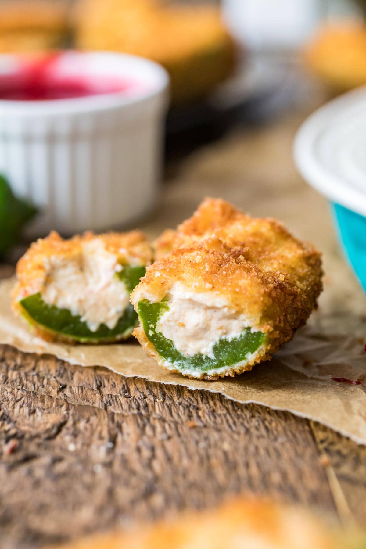 Jalapeno popper that has been cut in half to show its cream cheese filling.