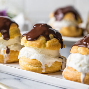 Ice cream filled profiteroles topped with chocolate ganache.