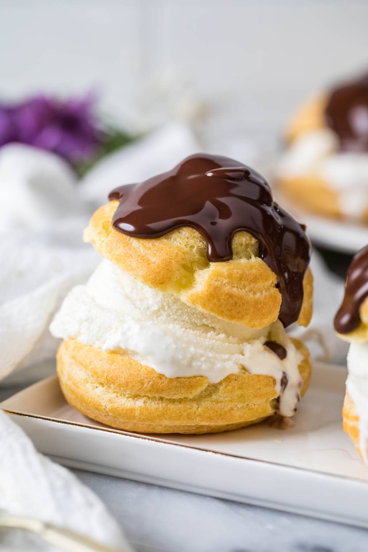 Choux bun filled with ice cream and topped with chocolate ganache.