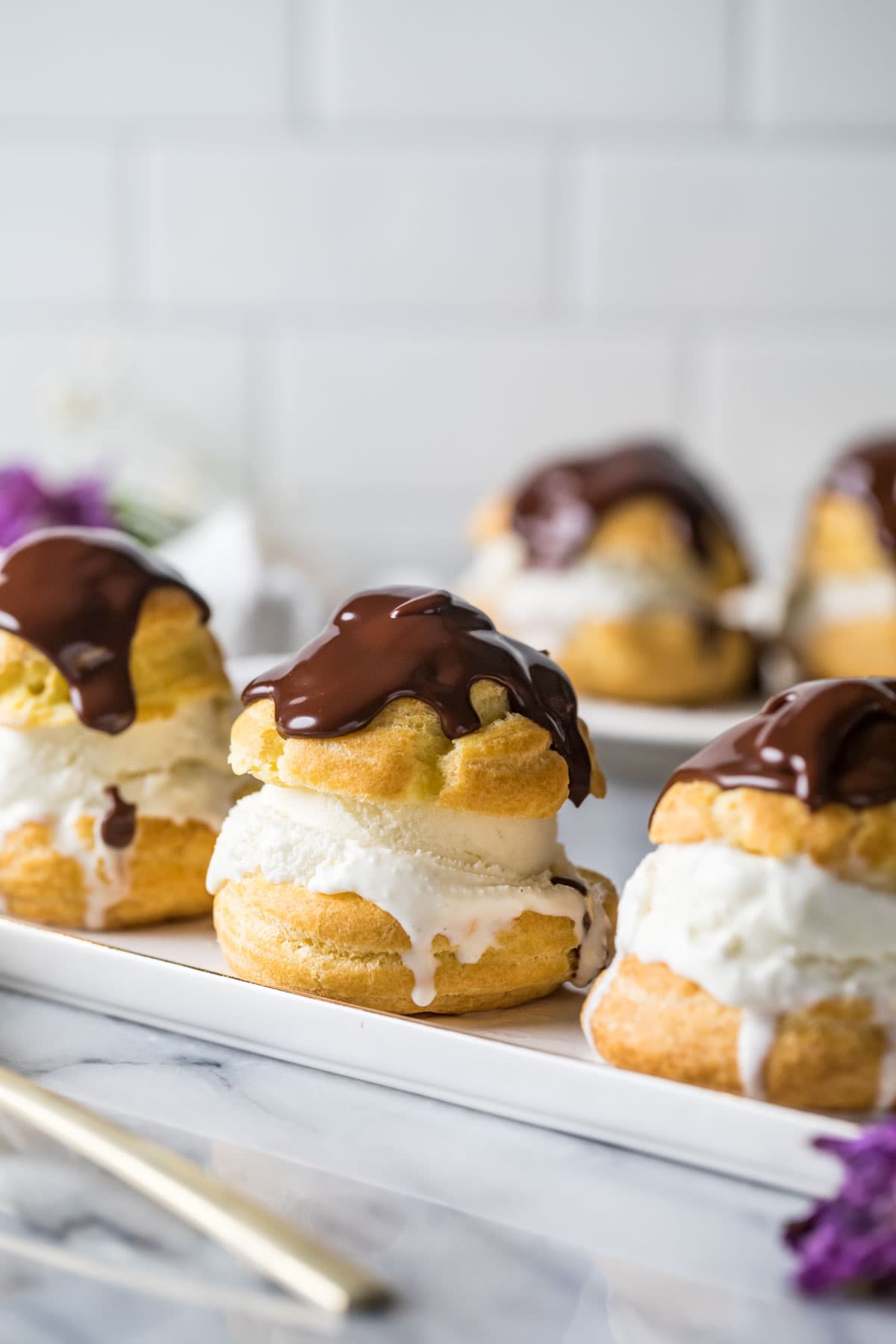 Ice cream filled profiteroles topped with chocolate ganache.