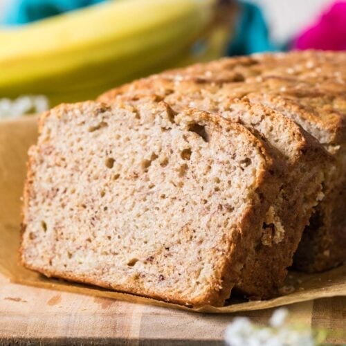 Slices of sourdough banana bread stacked against the remaining loaf.