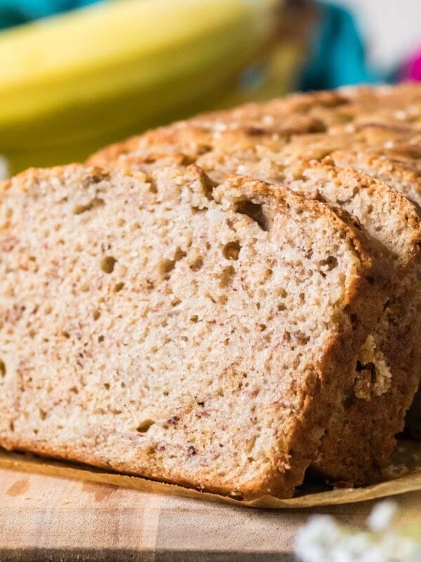 Slices of sourdough banana bread stacked against the remaining loaf.