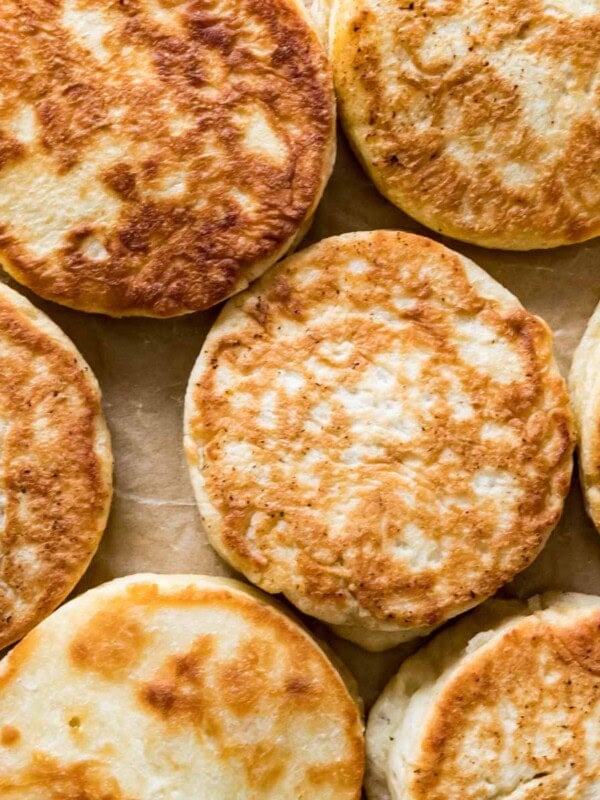 Overhead view of golden brown sourdough English muffins.